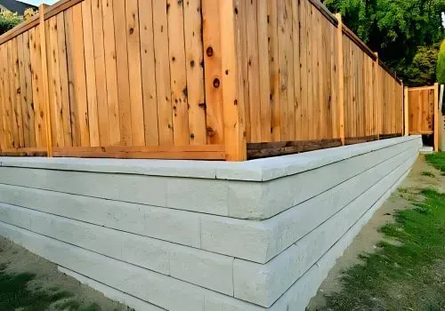 Dunedin retaining wall contractors are building a concrete and timber wall.