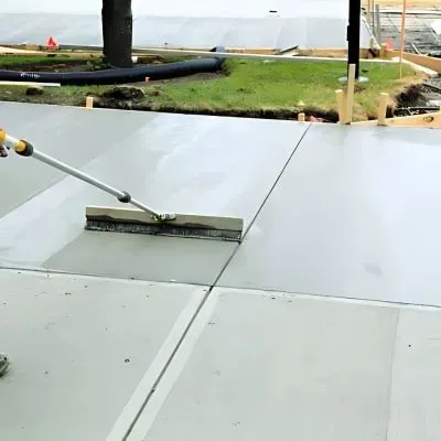 A new concrete driveway is being levelled for a Mosgiel business.