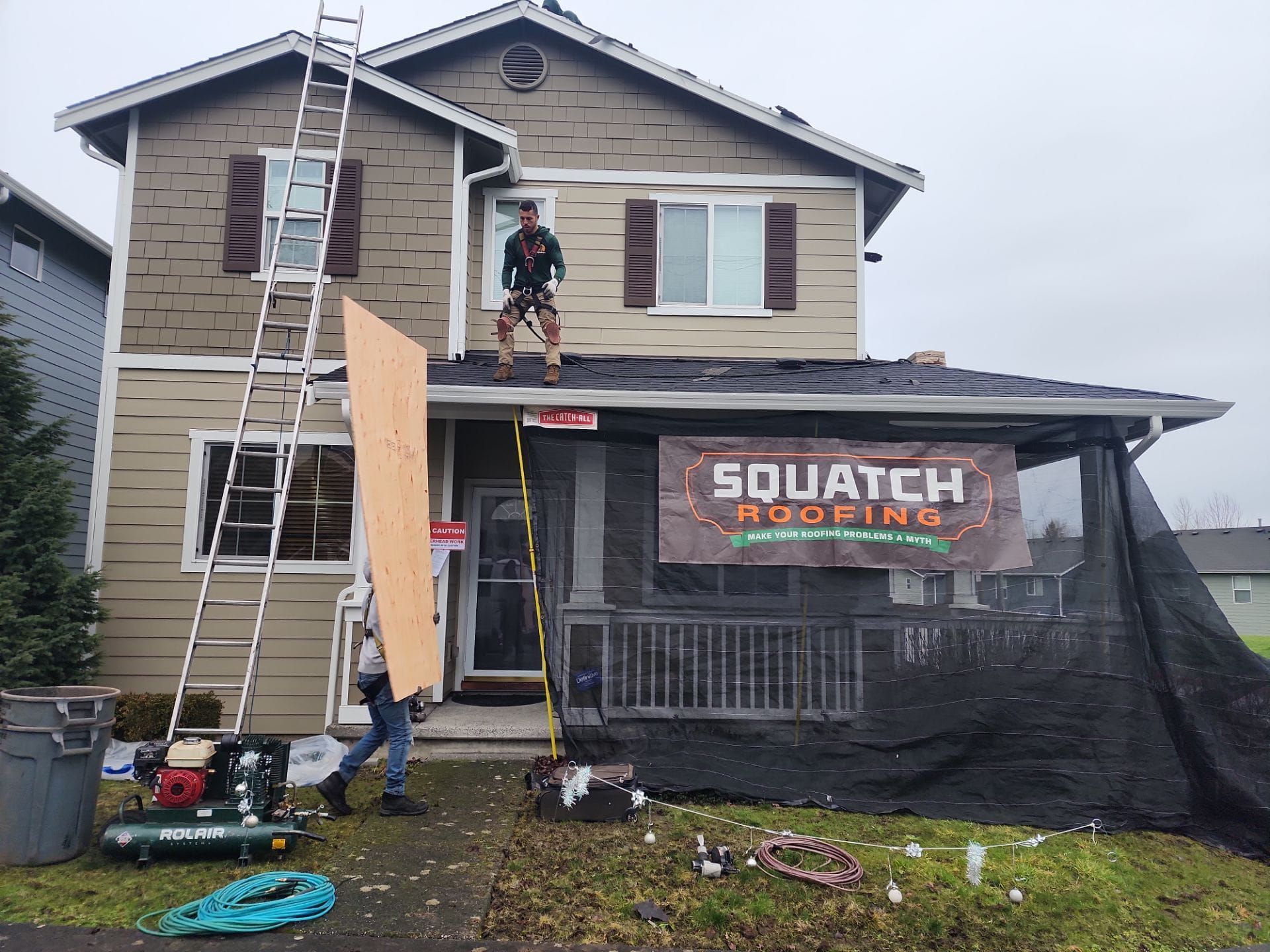 Roofers replacing house with new roof.