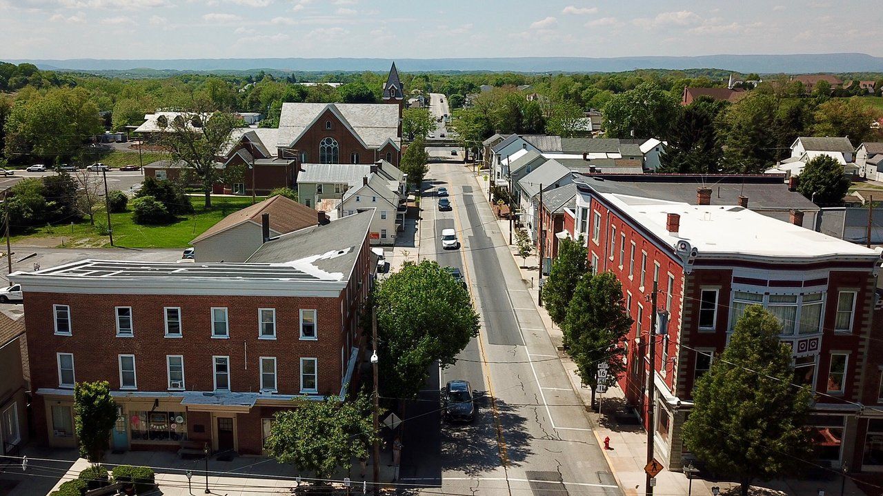 An aerial view of a small town with buildings and trees
