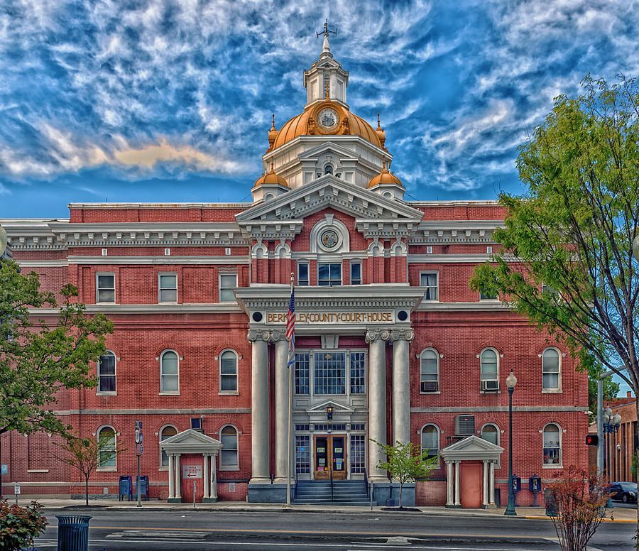A large red brick building with a dome on top A large red brick building with a dome on top