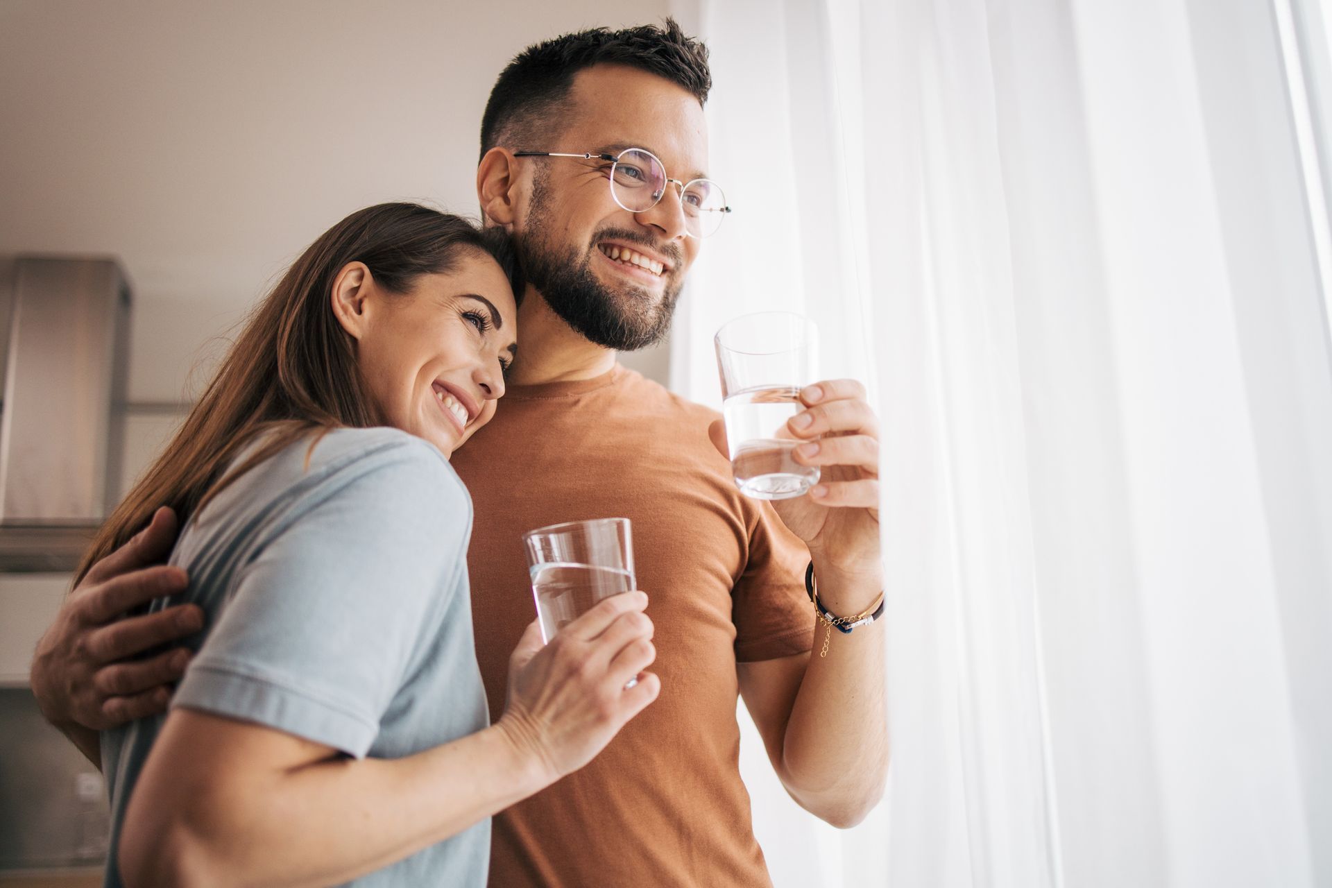 A Person Is Pouring Water Into A Glass From A Faucet — McAllen, TX — Clear Choice H2O