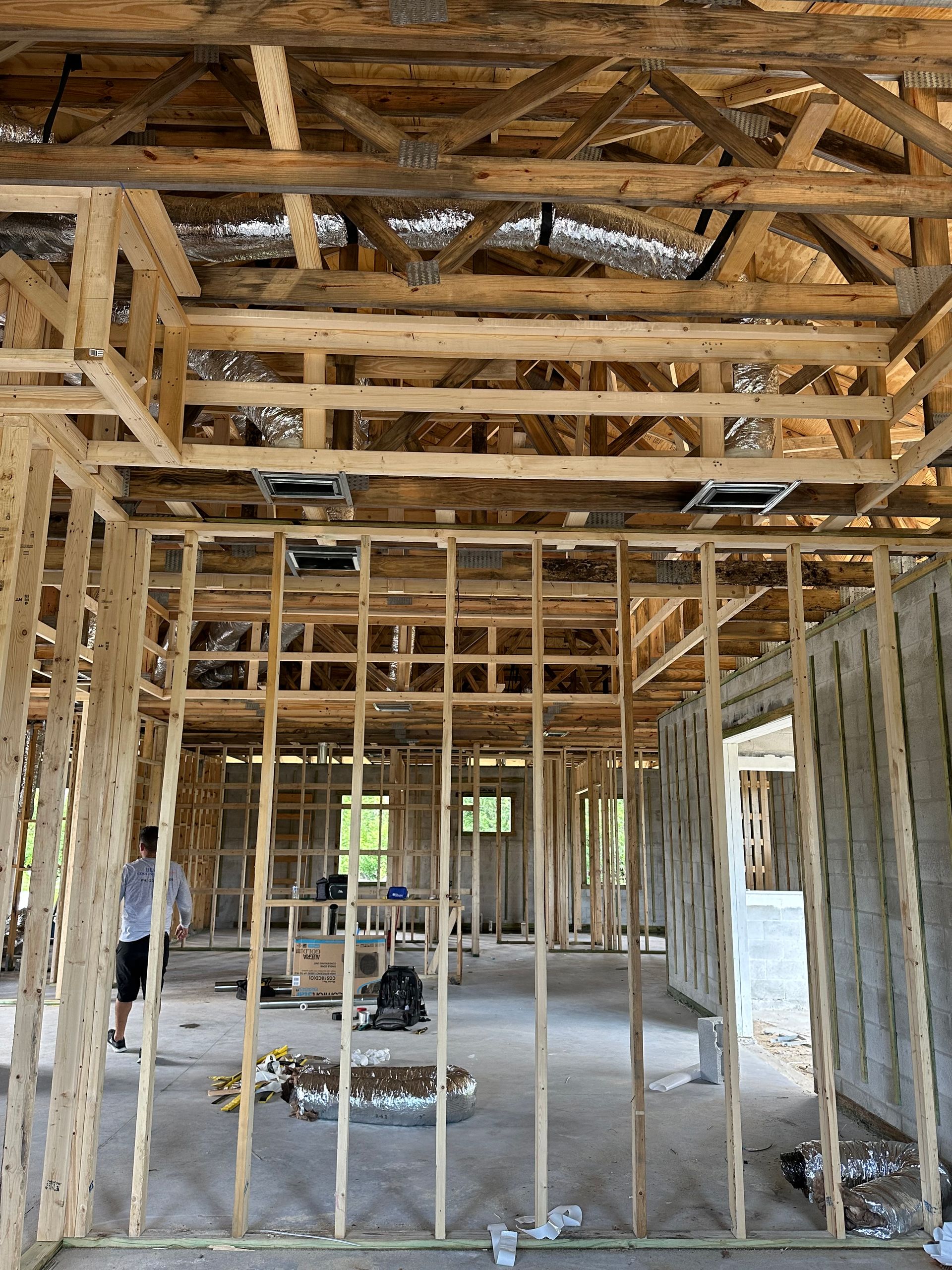The inside of a house under construction with wooden beams.