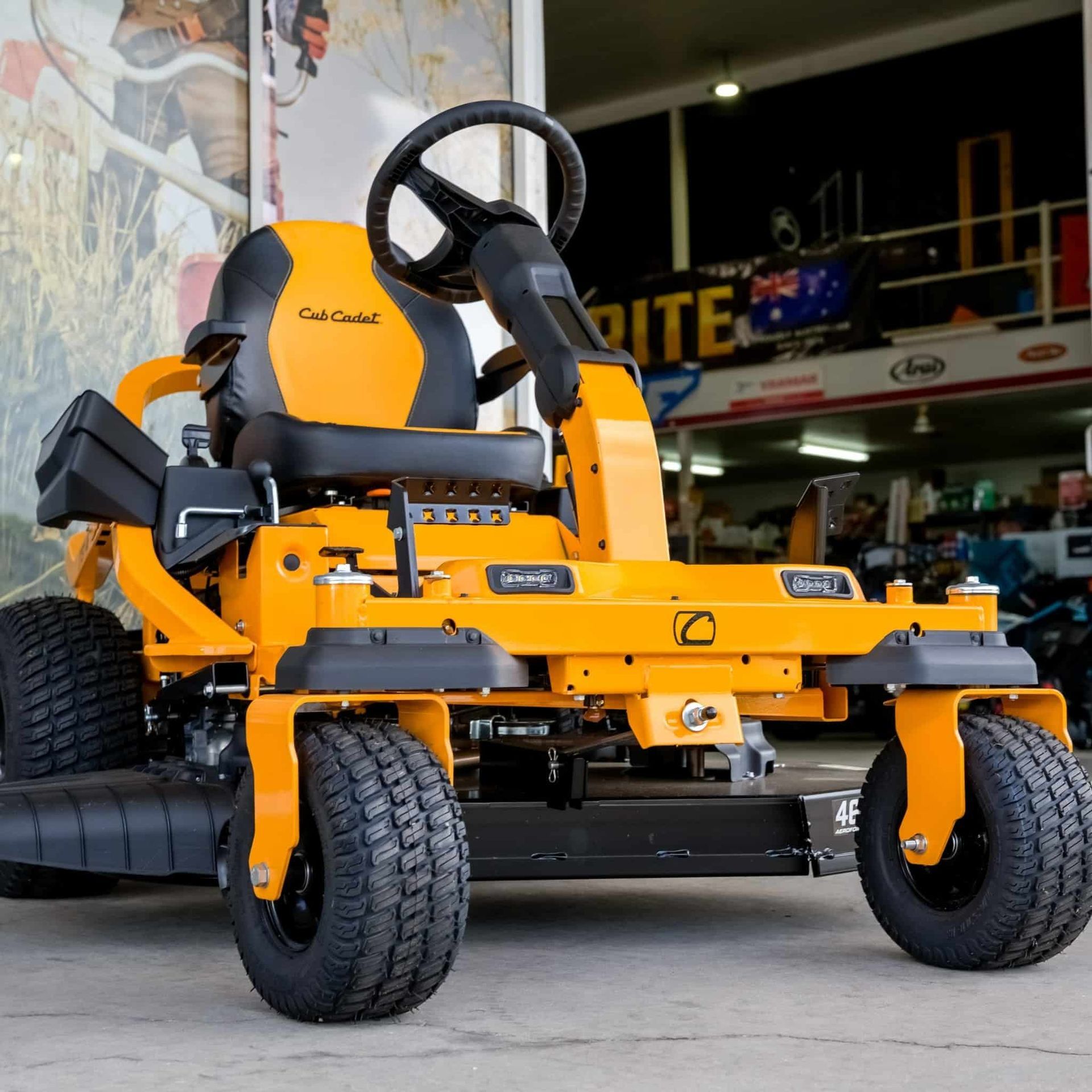 A Yellow Lawn Mower Is Parked In Front Of A Store — Coastal Farm & Motorcycles In Innisfail, QLD
