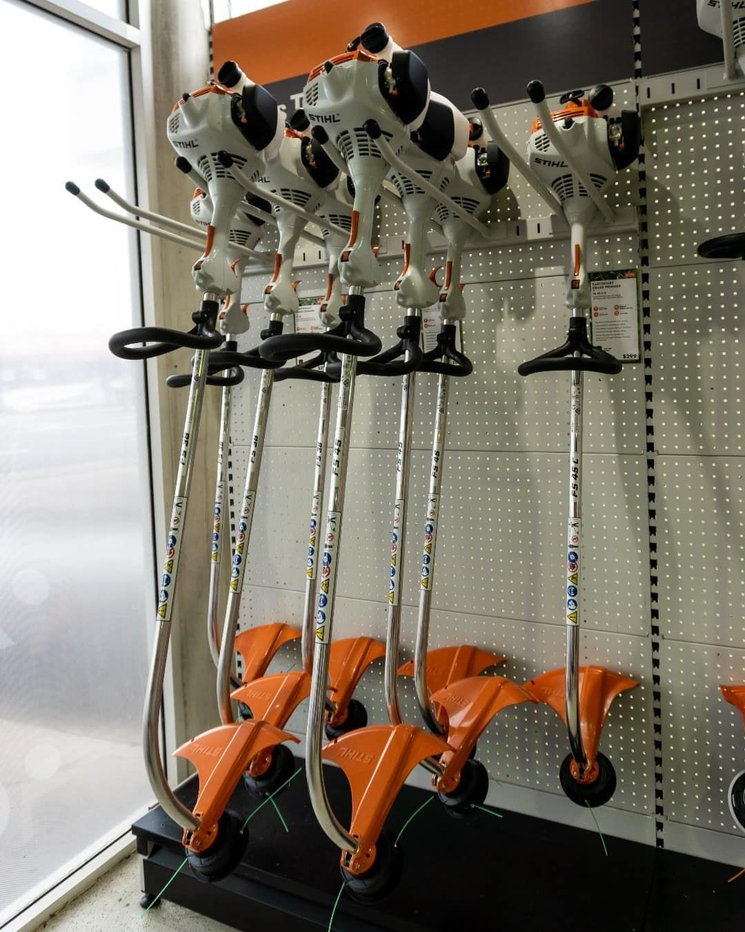 A Bunch Of Trimmers Are Hanging On A Wall — Coastal Farm & Motorcycles In Cairns, QLD