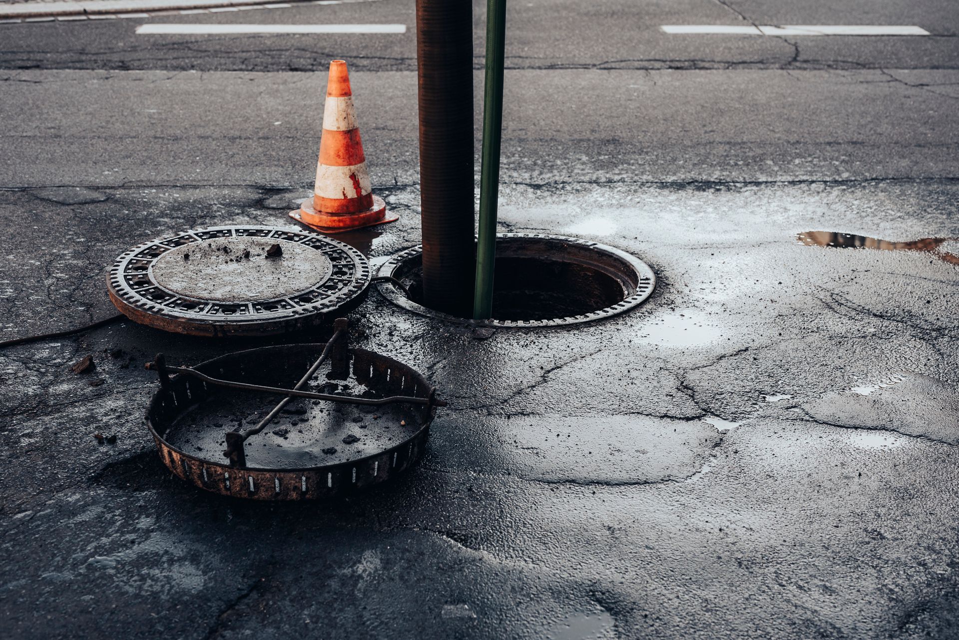 Cleaning the sewerage system on a road.
