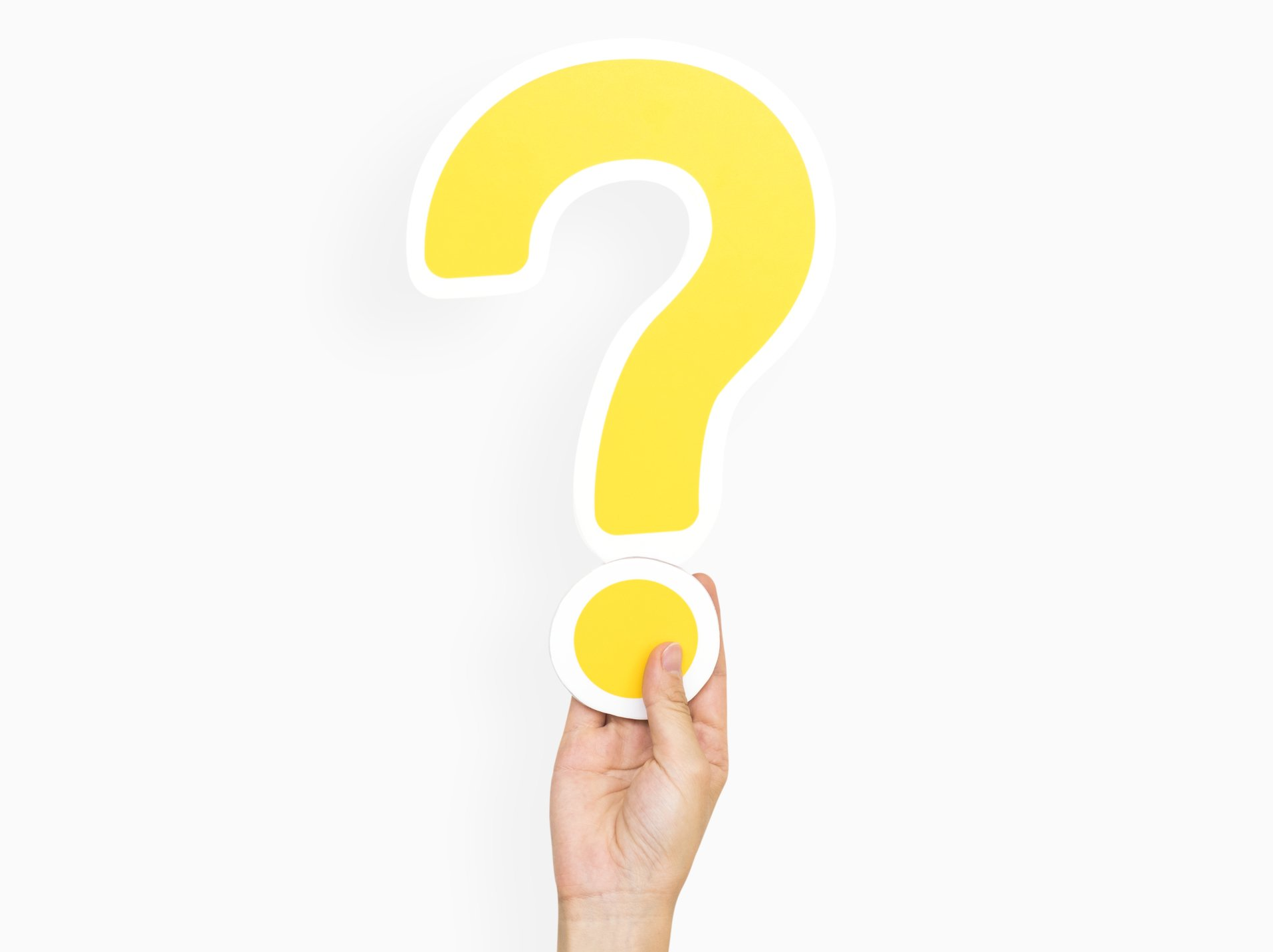 Hand holding a yellow question mark on a white background