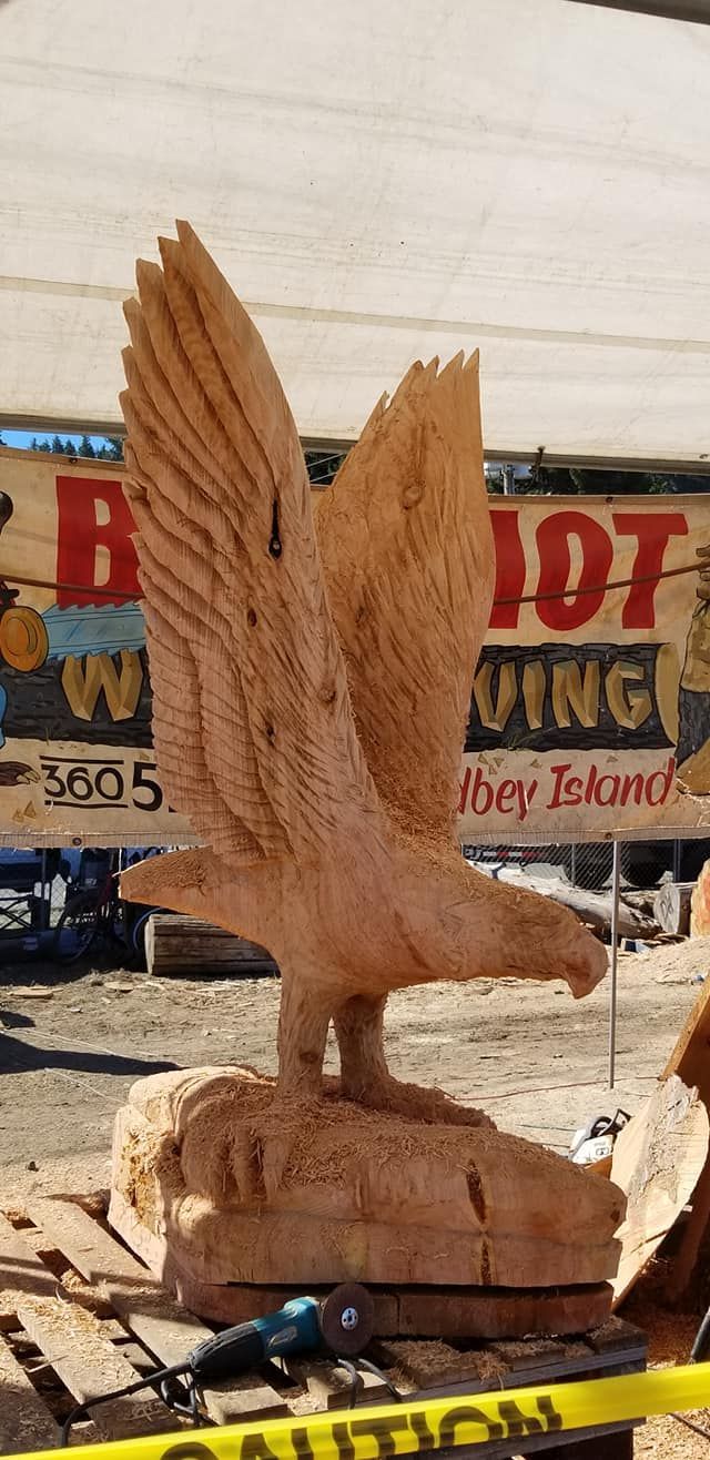 A wood carving of an eagle with its wings outstretched
