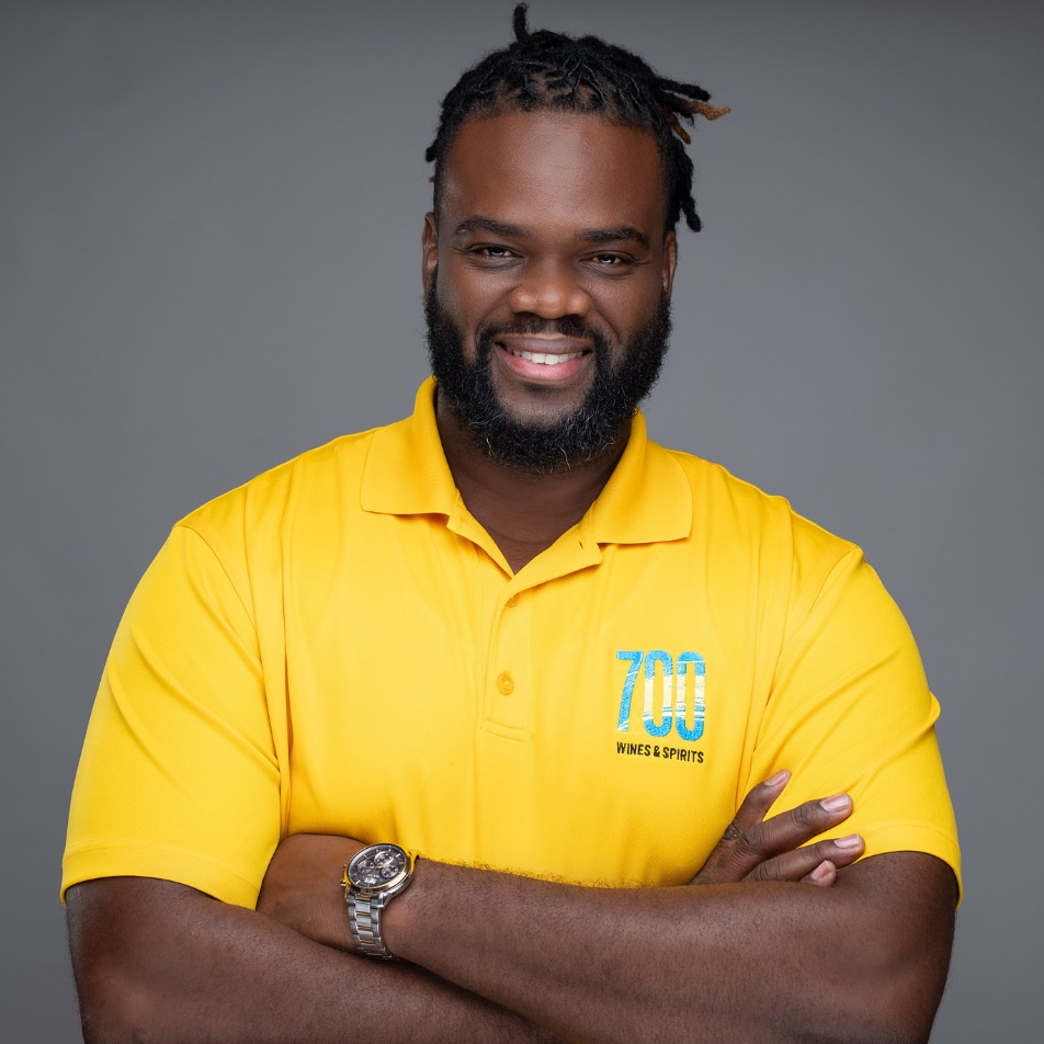 A man wearing a yellow shirt with the number 700 on it