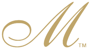 Gold cursive “M” logo with a small TM mark on a white background