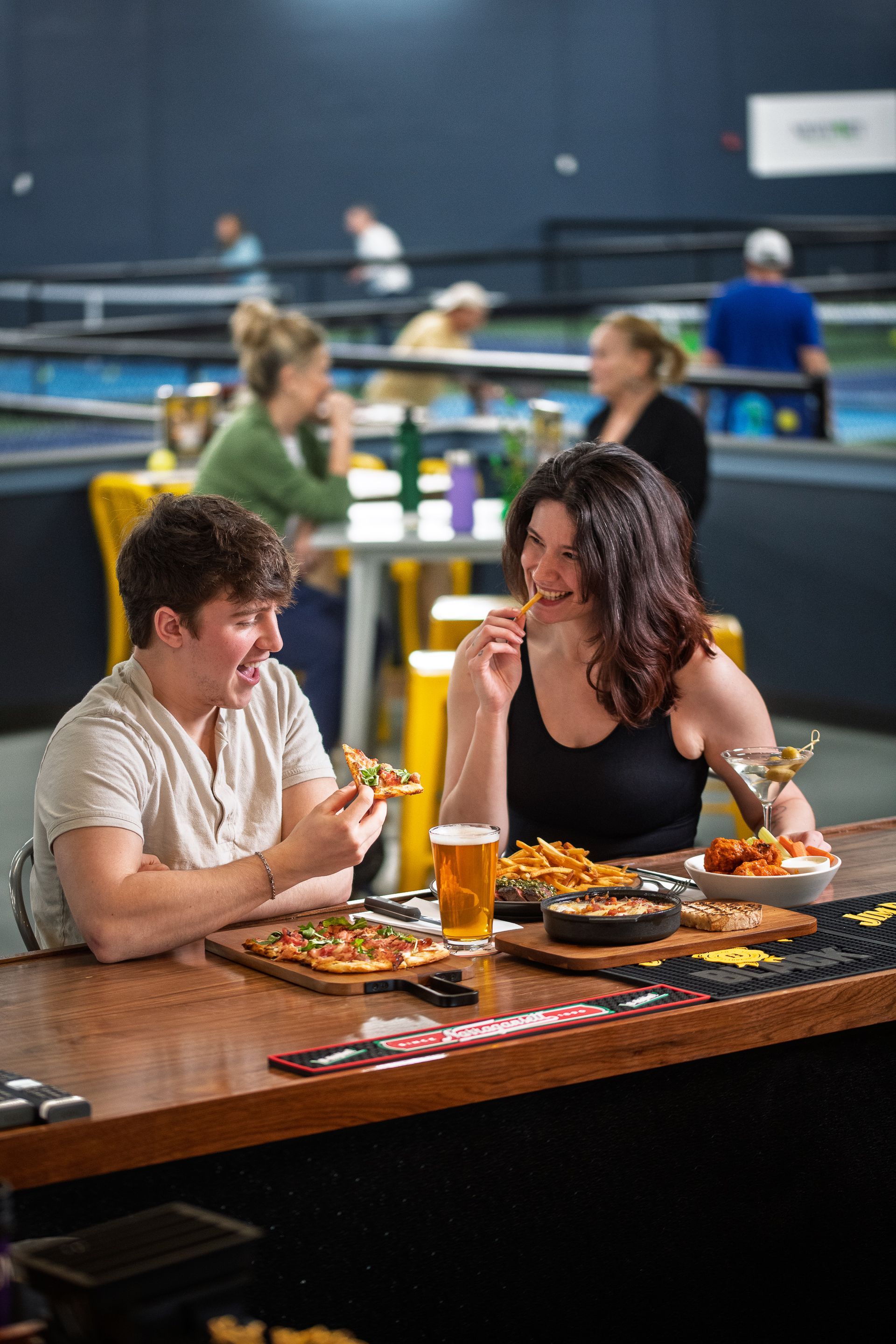 a couple enjoying snacks and drinks at the KITCHEN Table