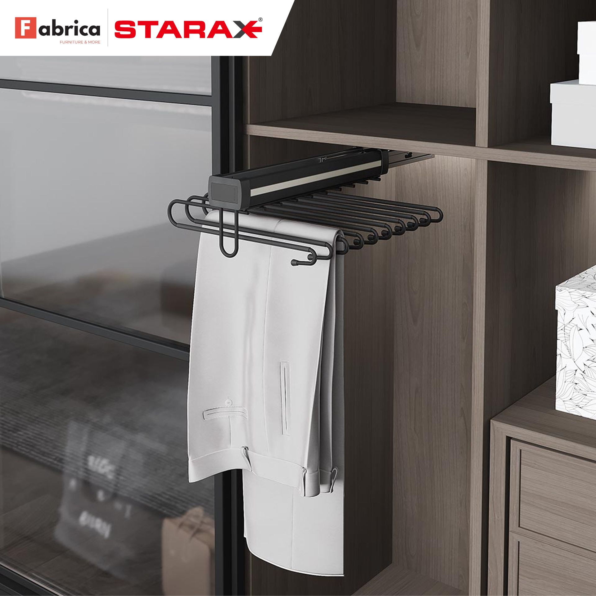 A pair of white pants hangs from a starax pants rack