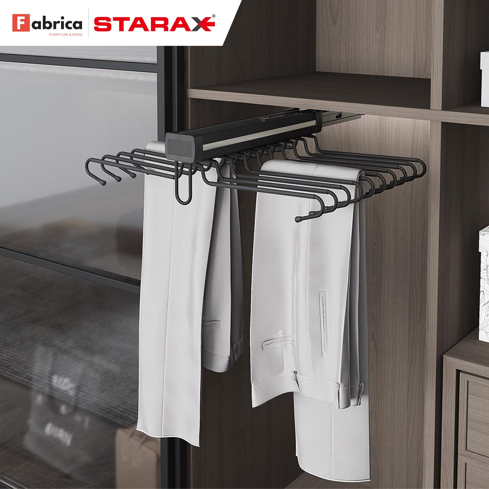 A pair of white pants hanging on a rack in a closet.