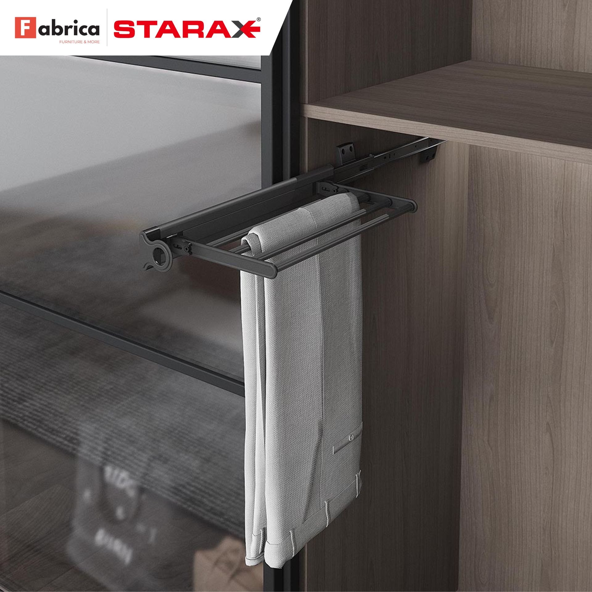 A pair of pants is hanging from a towel rack in a closet.