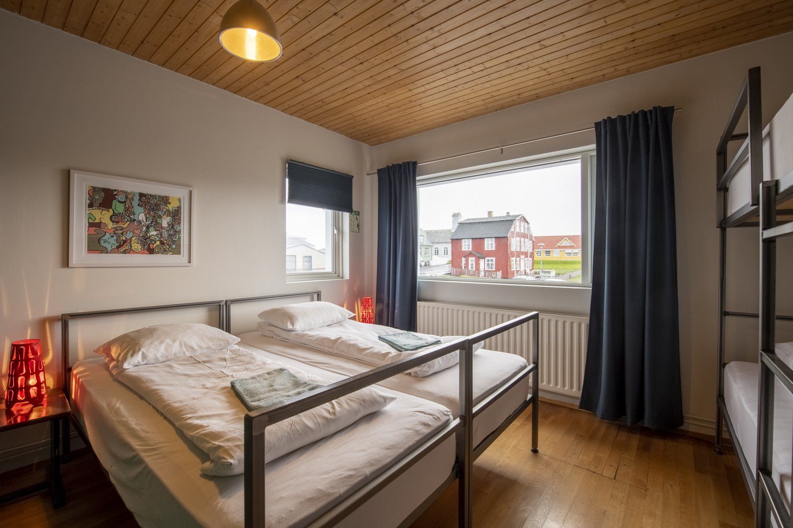 A bedroom with two beds and a bunk bed.