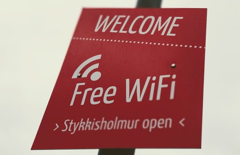 A red sign that says welcome free wifi