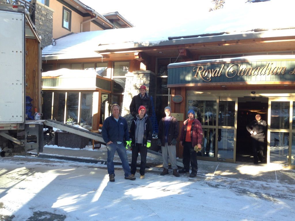 A group of people standing in front of a building that says royal