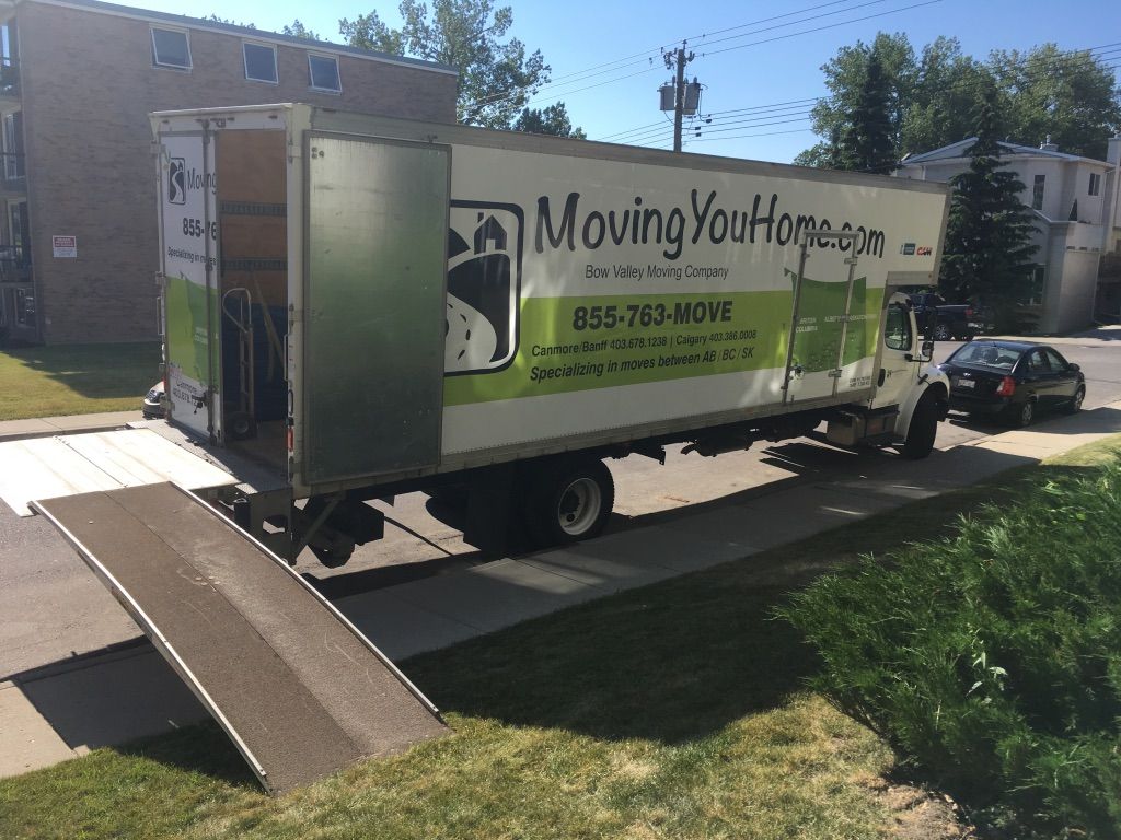 A moving truck is parked on the side of the road