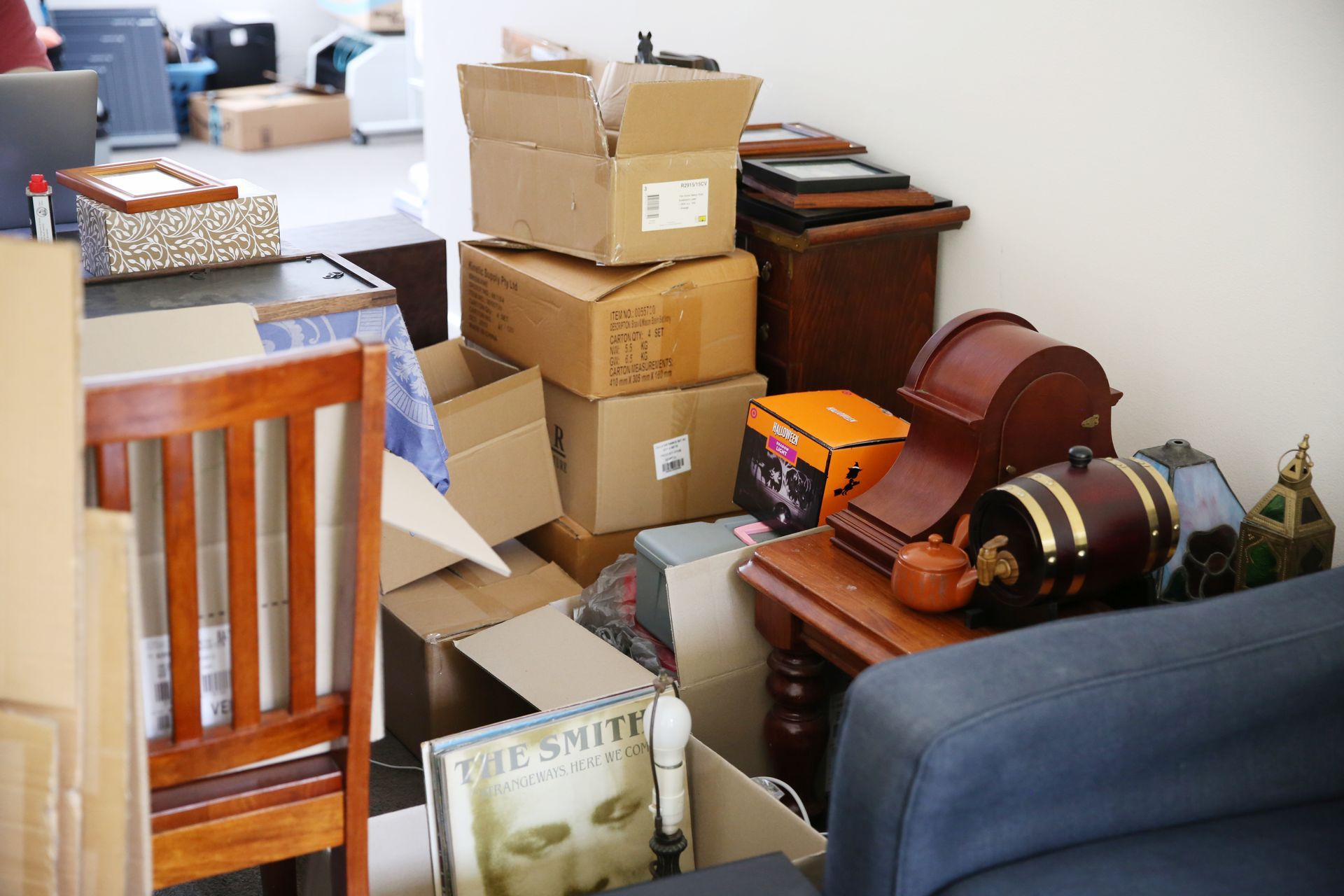 A cluttered wooden shed with bicycles, tools, and storage shelves.