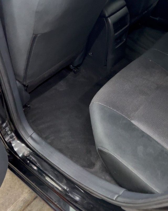 Rear floor after a shampoo interior detail — clean carpet