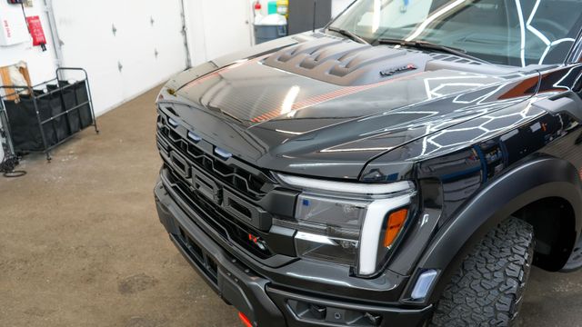 Black Ford truck front end after a full detail