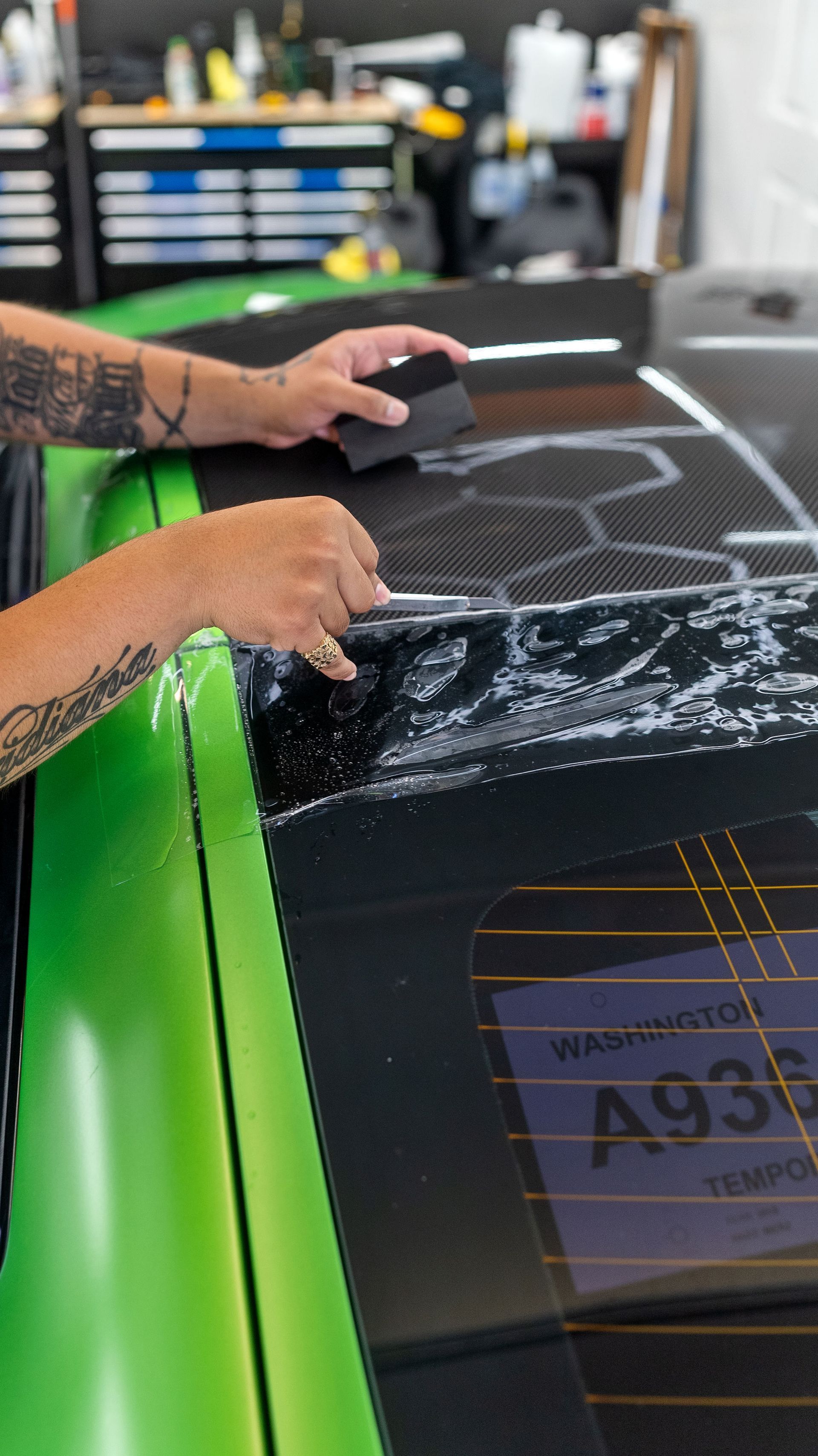 Vinyl wrap smoothed onto a body panel