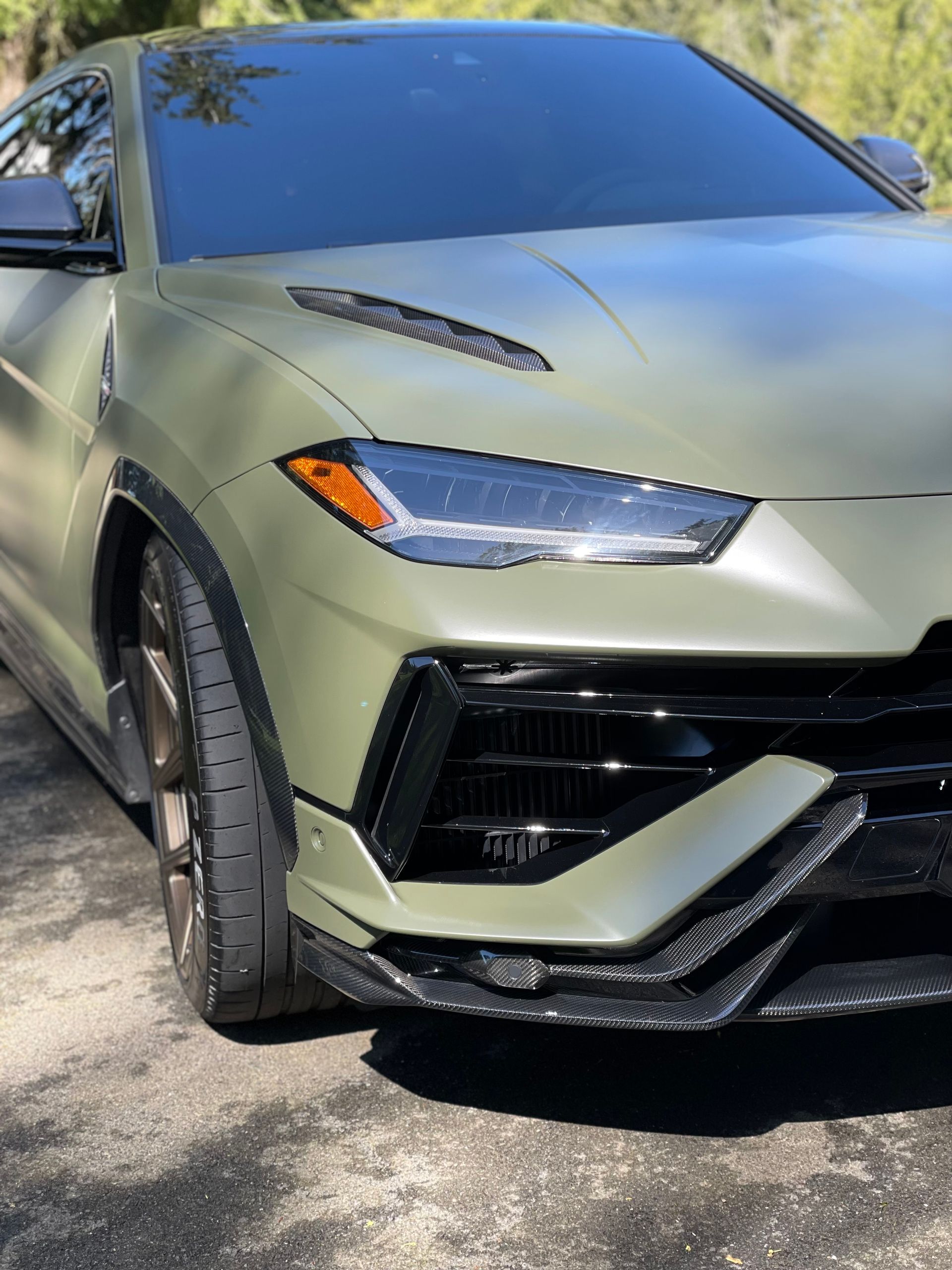 Front end of a matte green Lamborghini Urus detailed at our Lynnwood shop