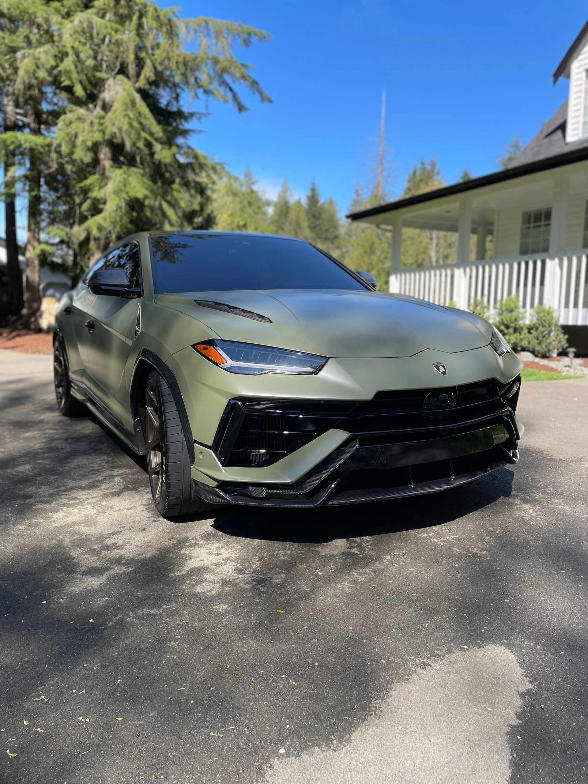 Matte green Lamborghini Urus parked outside after a full detail