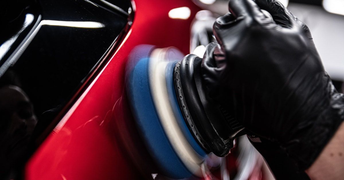 Buffing pad correcting swirl marks in car paint