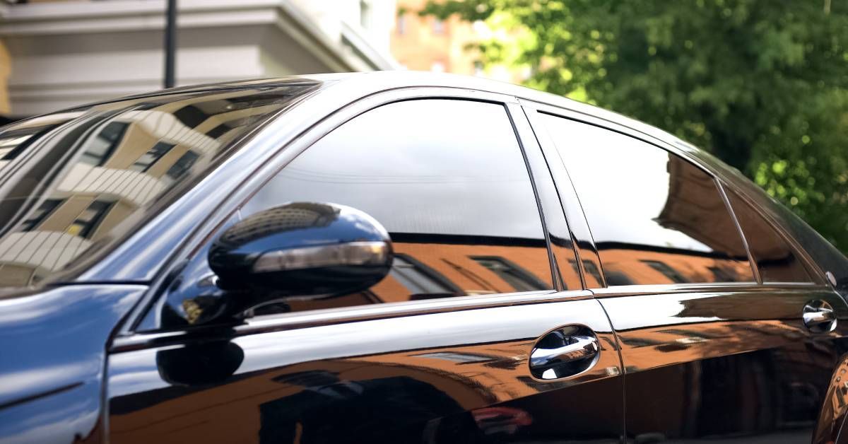 Car window being tinted by a professional installer