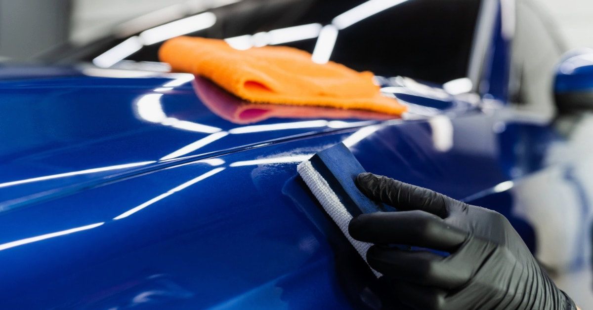 Ceramic coating being applied to a car body panel
