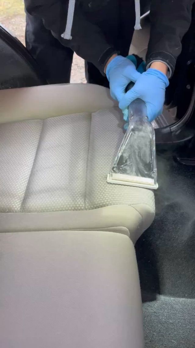 Steam cleaning and shampooing a car interior