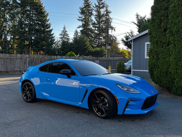 Glossy blue coupe after a mobile exterior detail in a customer's driveway