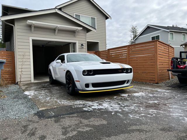 White muscle car detailed in a customer's driveway