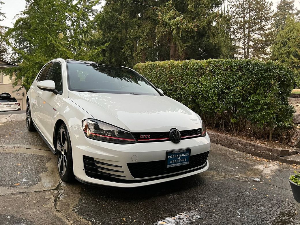 Freshly detailed white VW Golf GTI in a customer's driveway — A1 mobile detailing