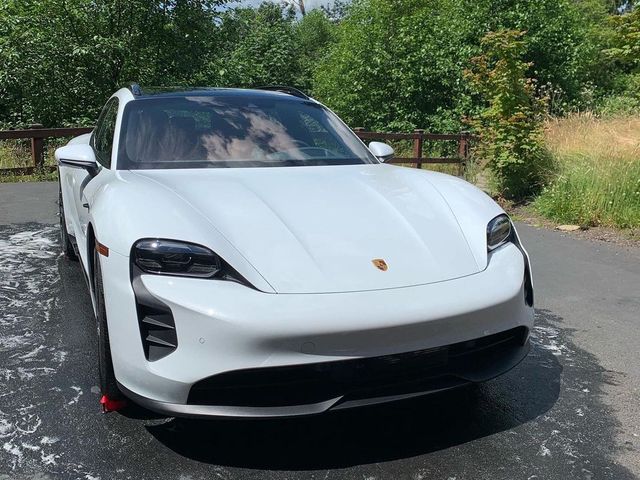 White sports sedan detailed in a customer's driveway