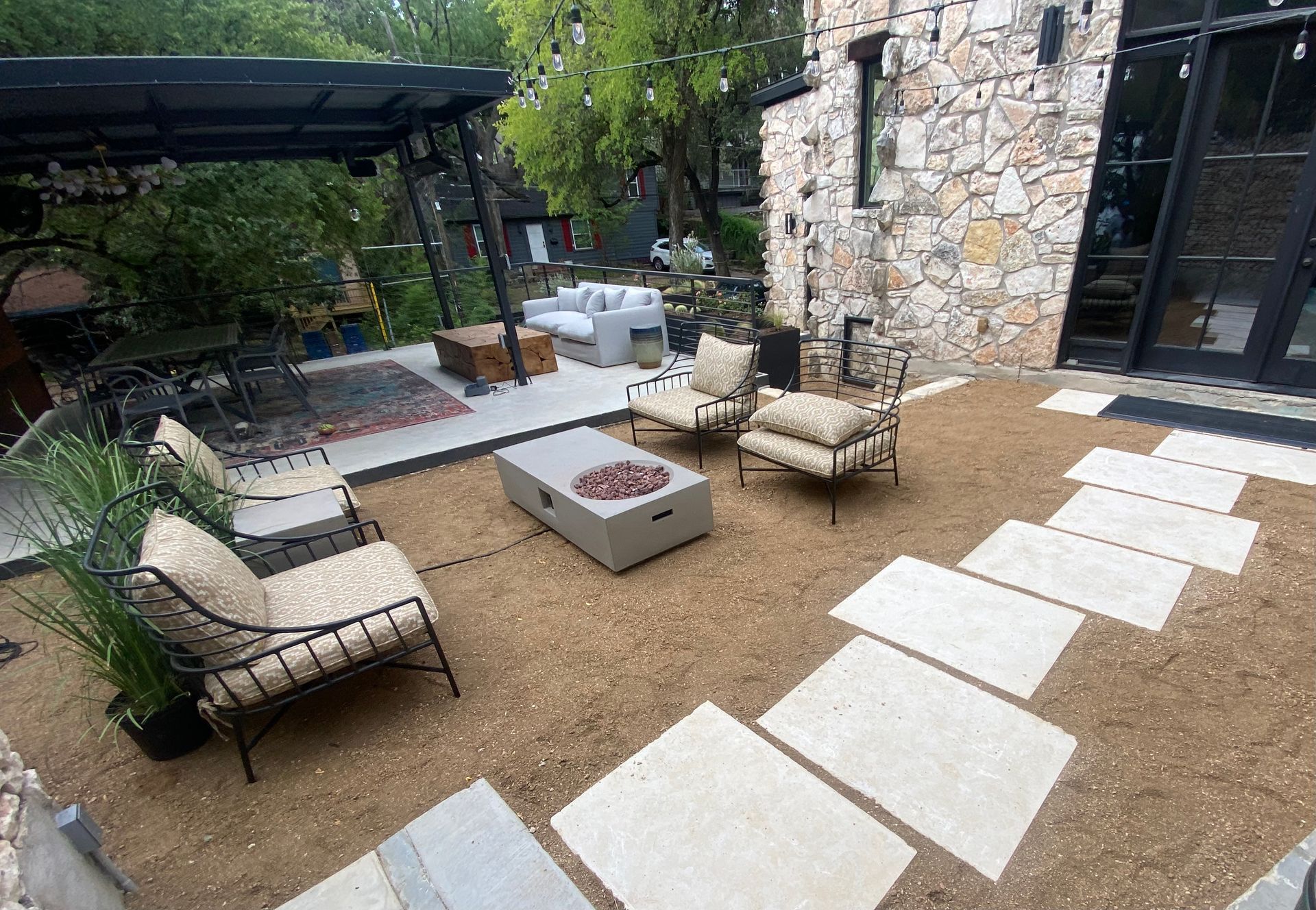 There is a fire pit in the middle of the patio.
