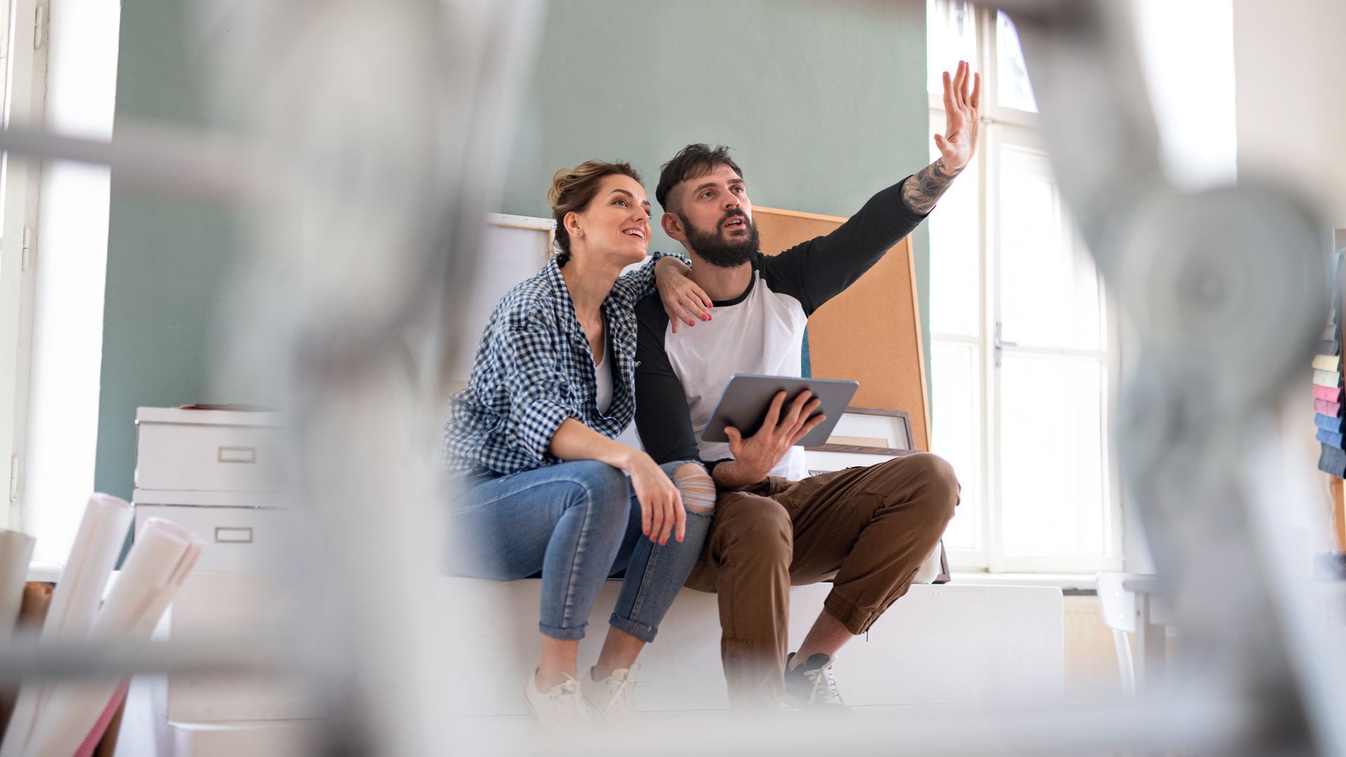 man and woman sitting and imagining home renovation plans