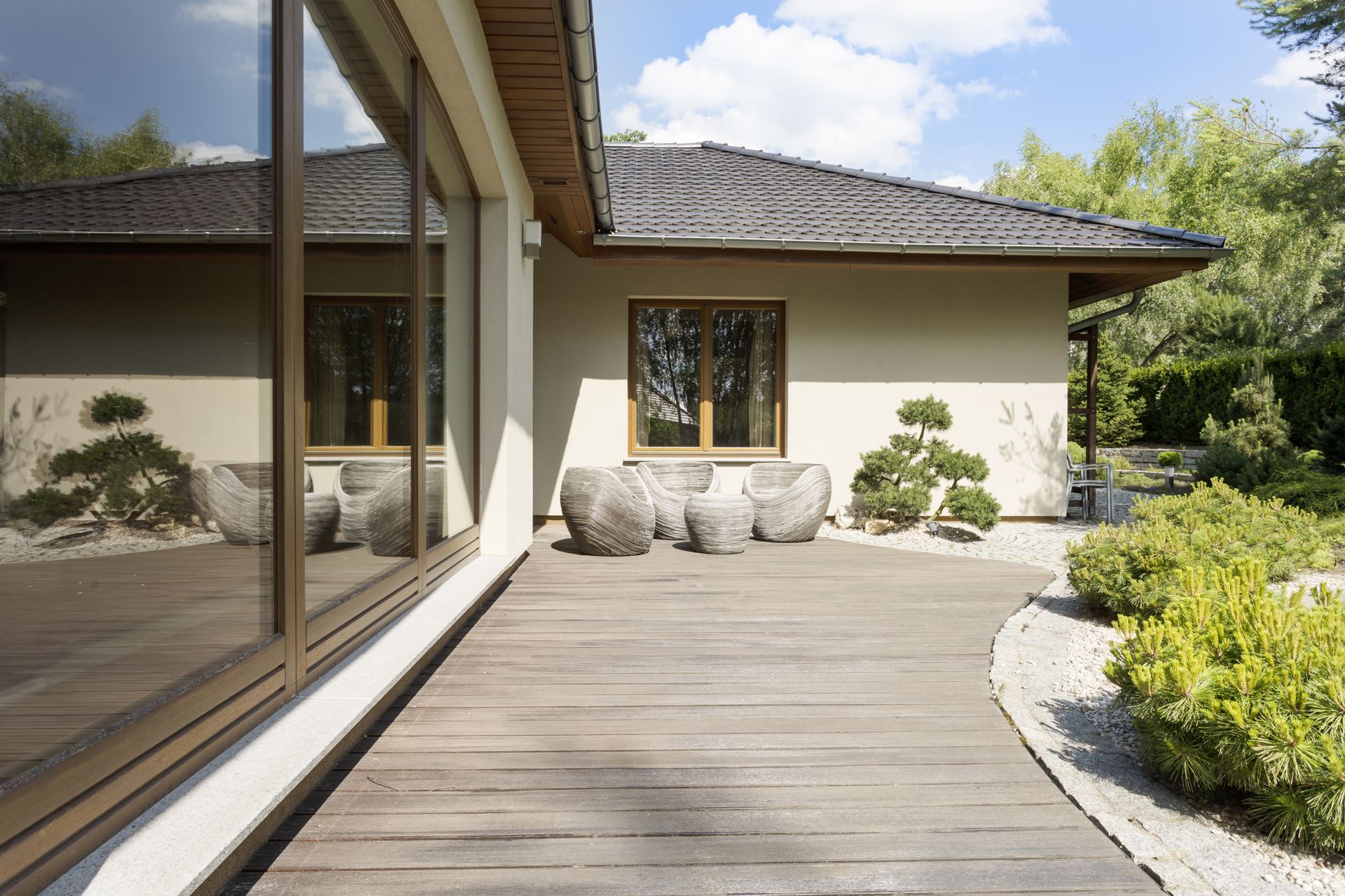 light colored curved deck against house wall