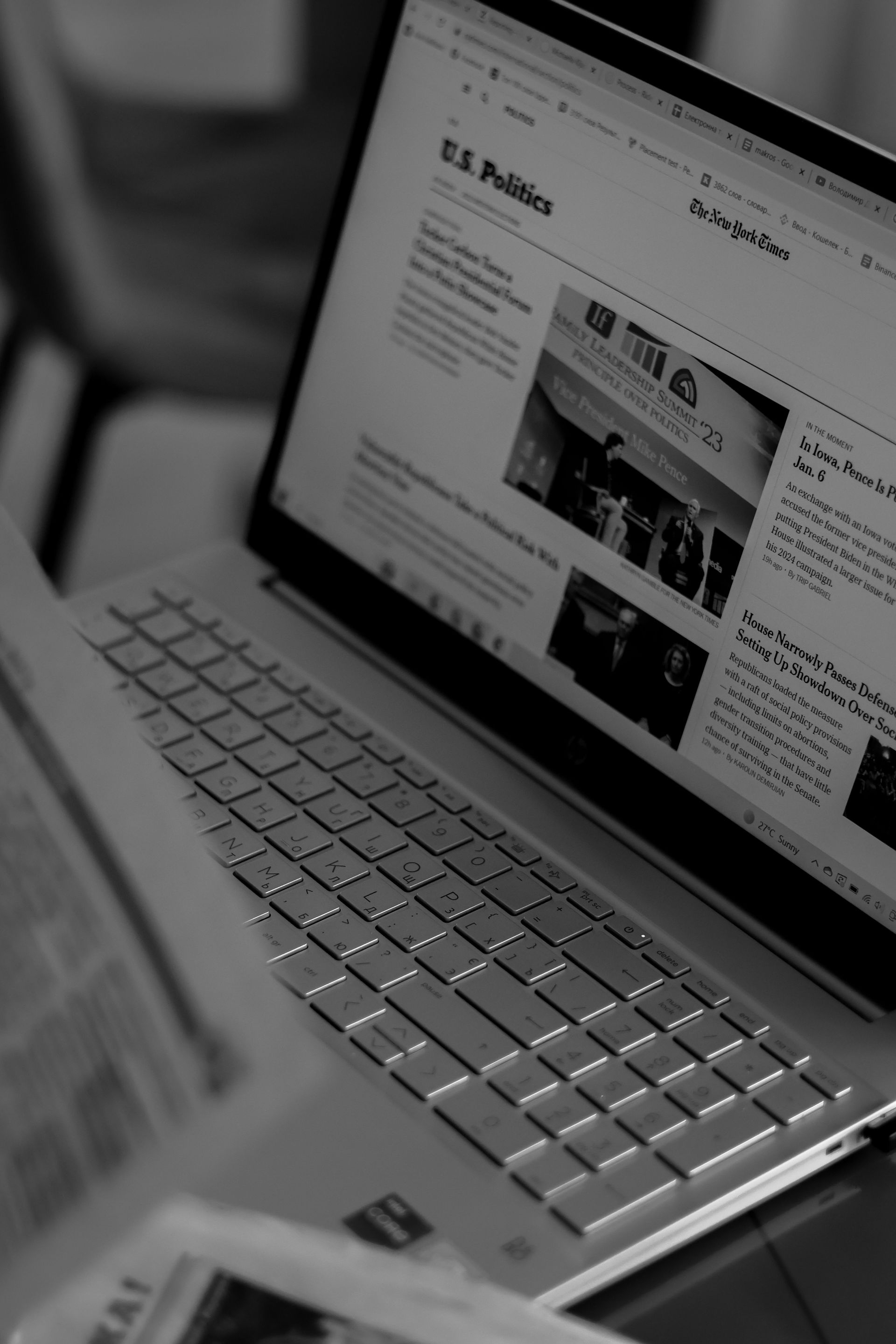 Silver laptop on a desk, showing a website on the screen.