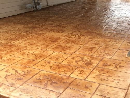 A close up of a concrete floor with a brick pattern.