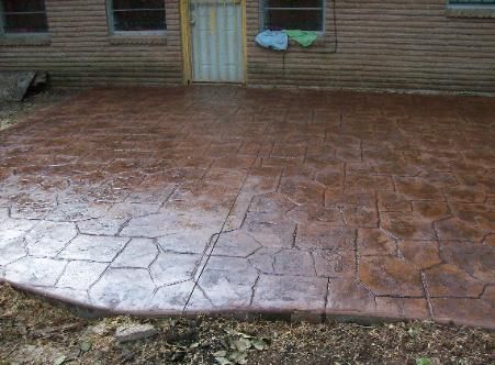 A brick house with a patio in front of it