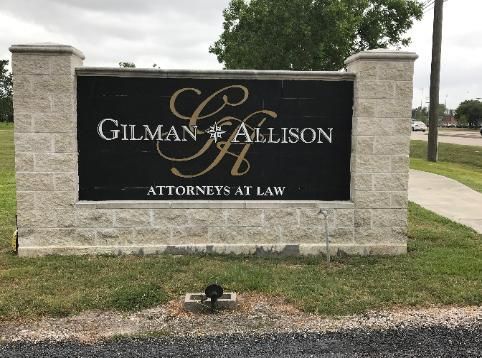 A sign for gilman and allison attorneys at law
