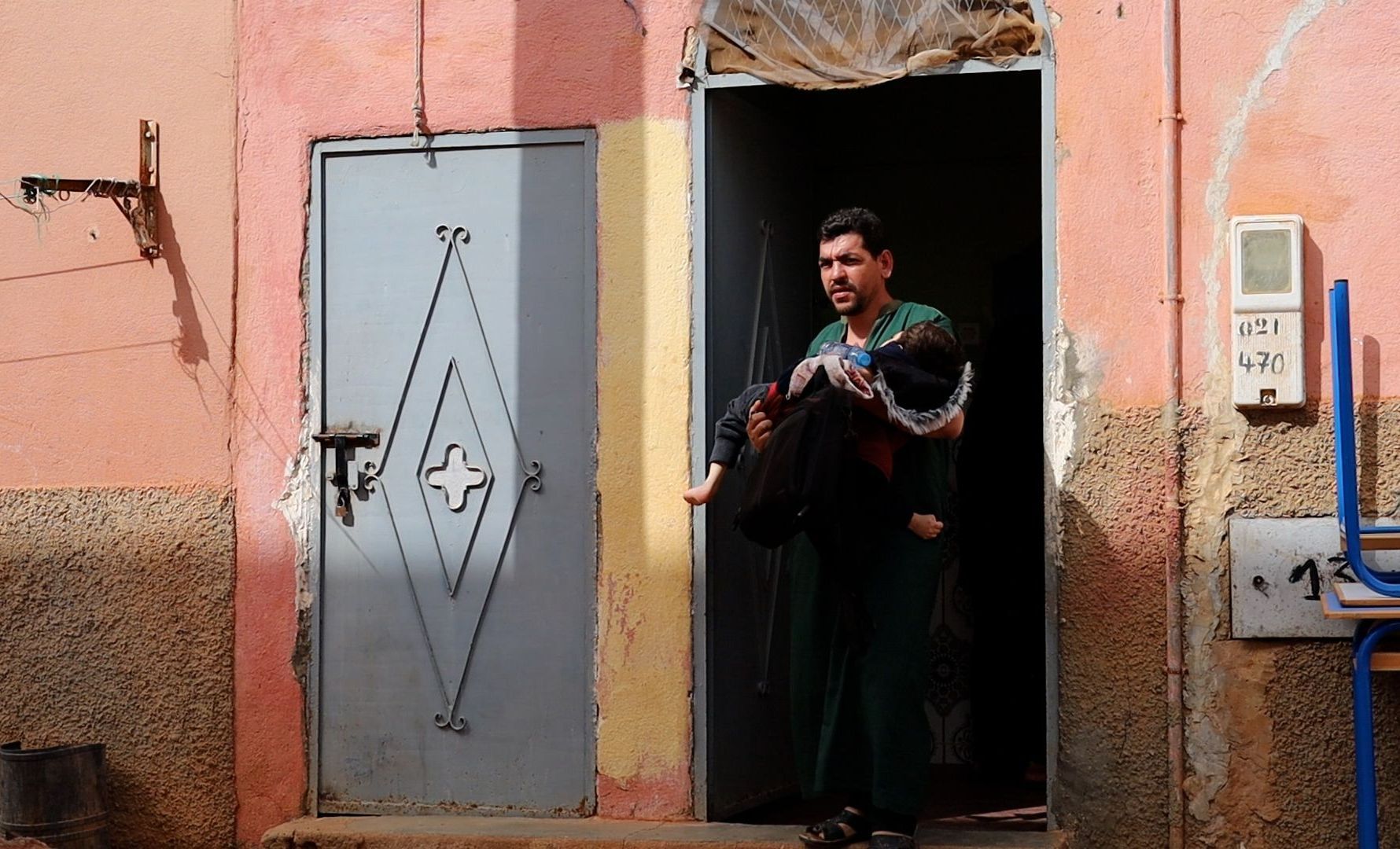 Moroccan man holding son with a disability