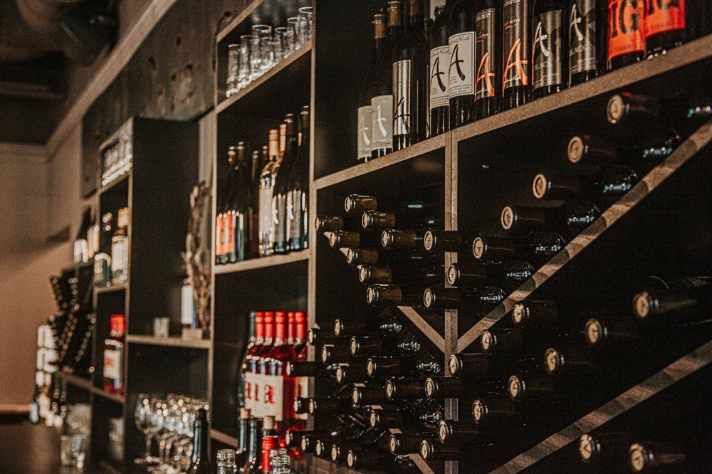 Shelves stocked with various bottles and jars in a dark room.