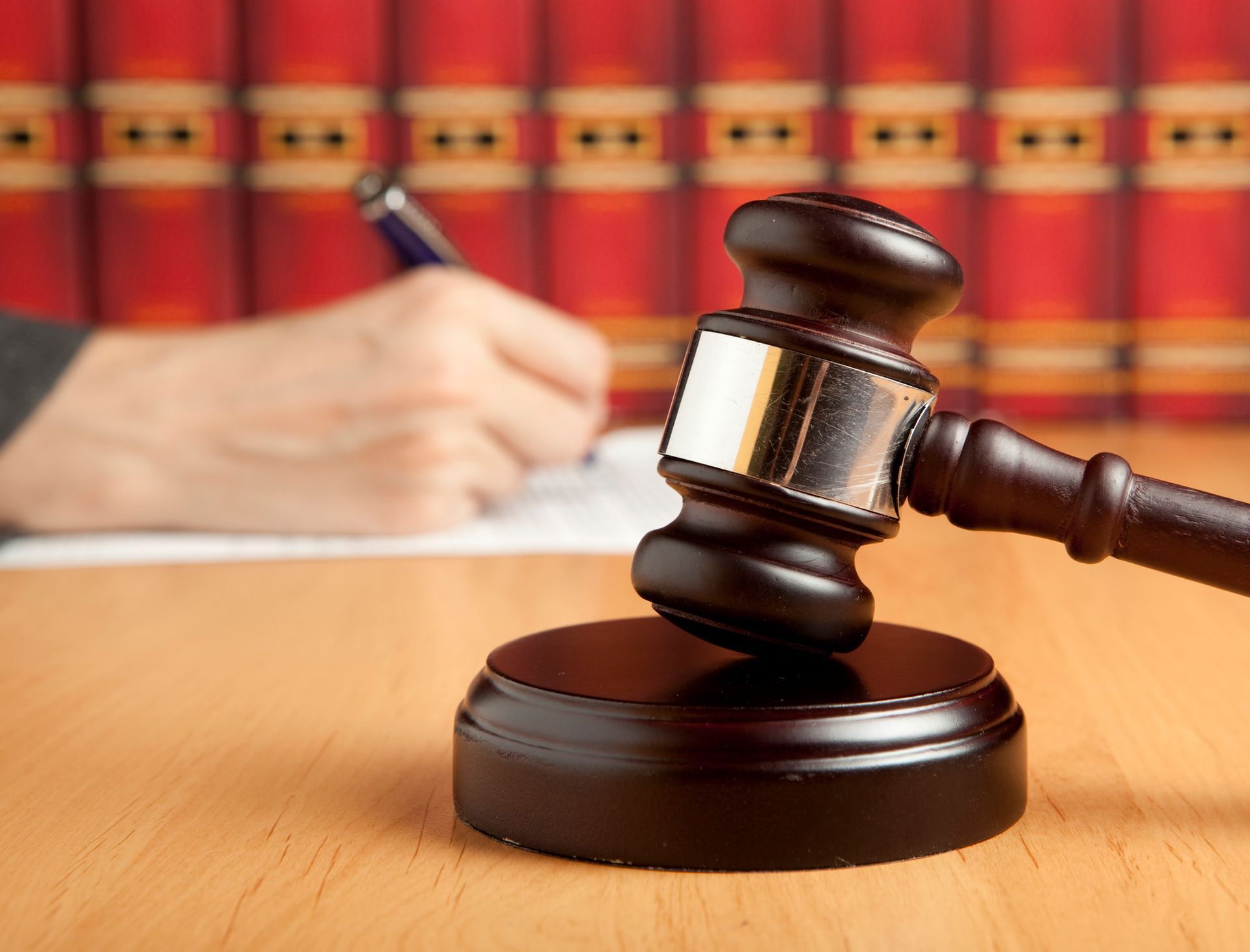 A gavel and a person writing | Grayson, KY | Law Offices of Robert W Miller A gavel and a person writing | Grayson, KY | Law Offices of Robert W Miller
