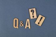 Wooden “Q&A” letters with a question mark and exclamation mark on a blue background