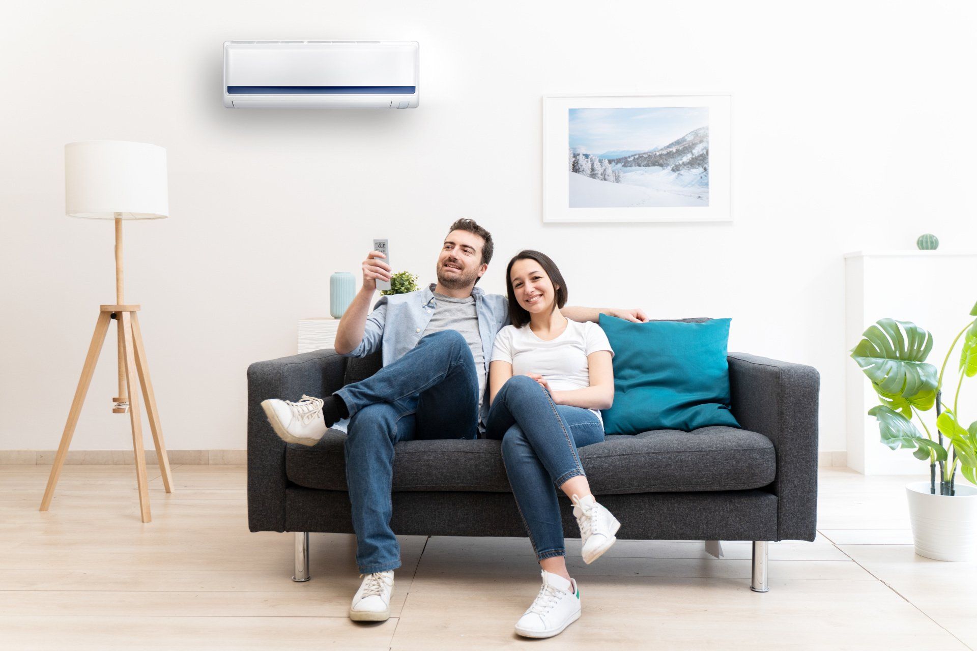 A man and a woman are sitting on a couch in a living room.