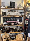 A retail store display featuring multiple wooden shelves filled with various necklaces, bracelets, earrings, and jewelry.