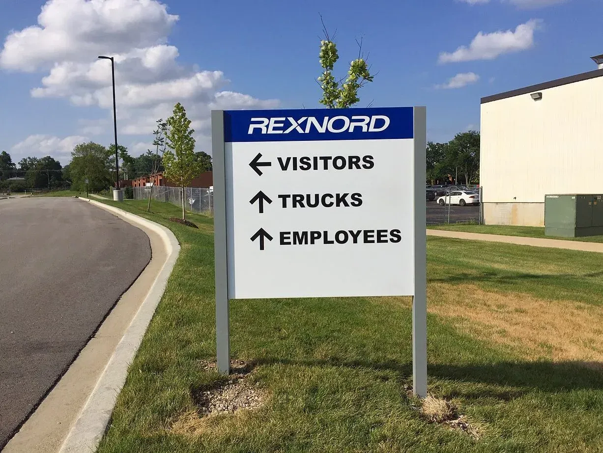 Sign directing visitors, trucks, and employees at Rexnord.
